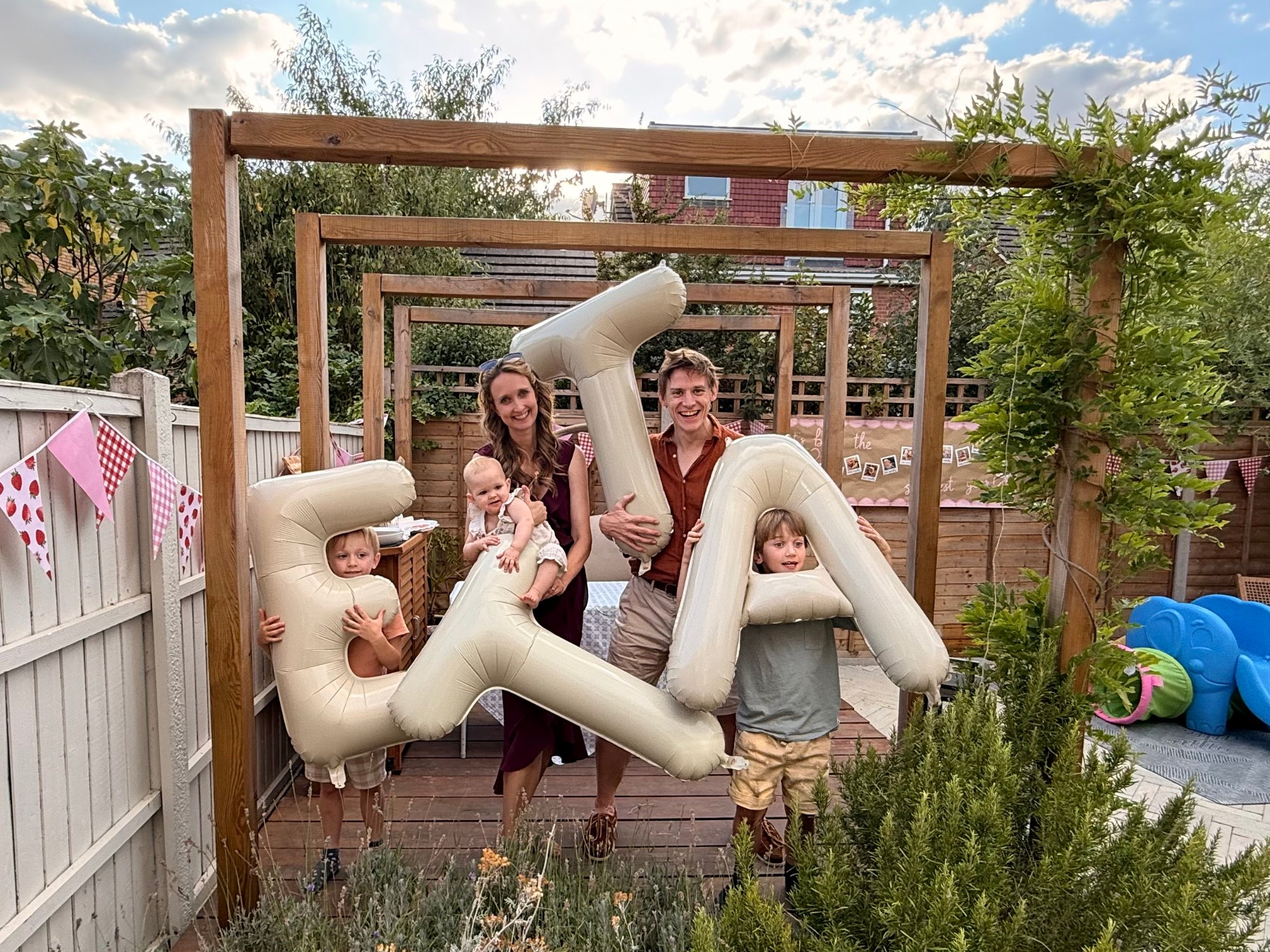 Charlie and family posing with inflatable letters.